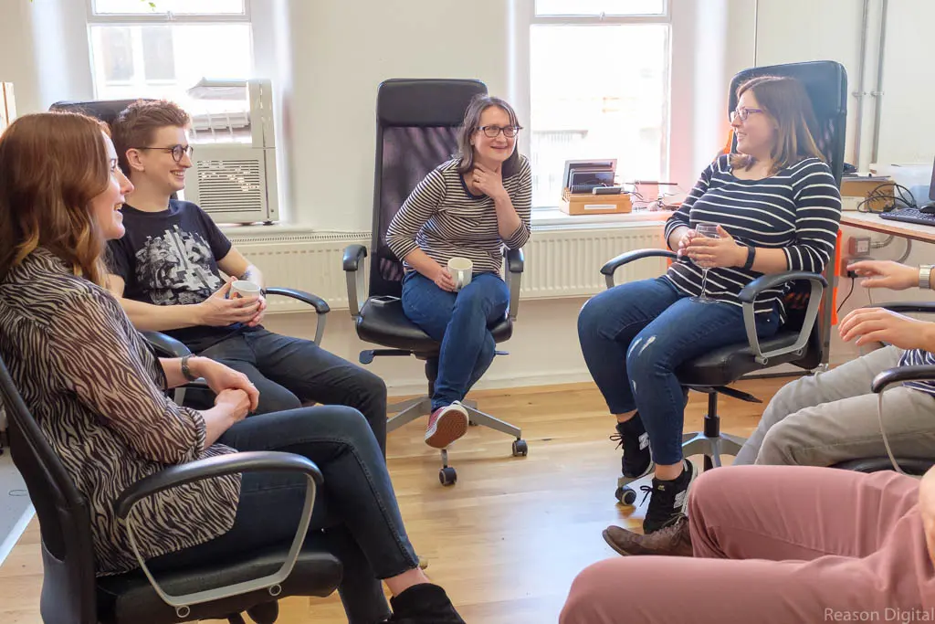 team members sat in a circle talking