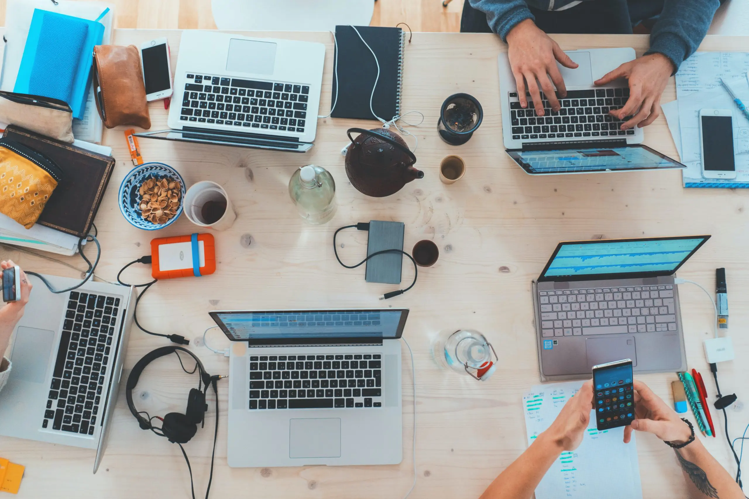 birds eye view of laptops and phones on a desk