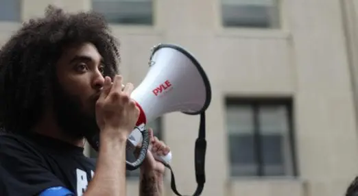 man speaking into megaphone