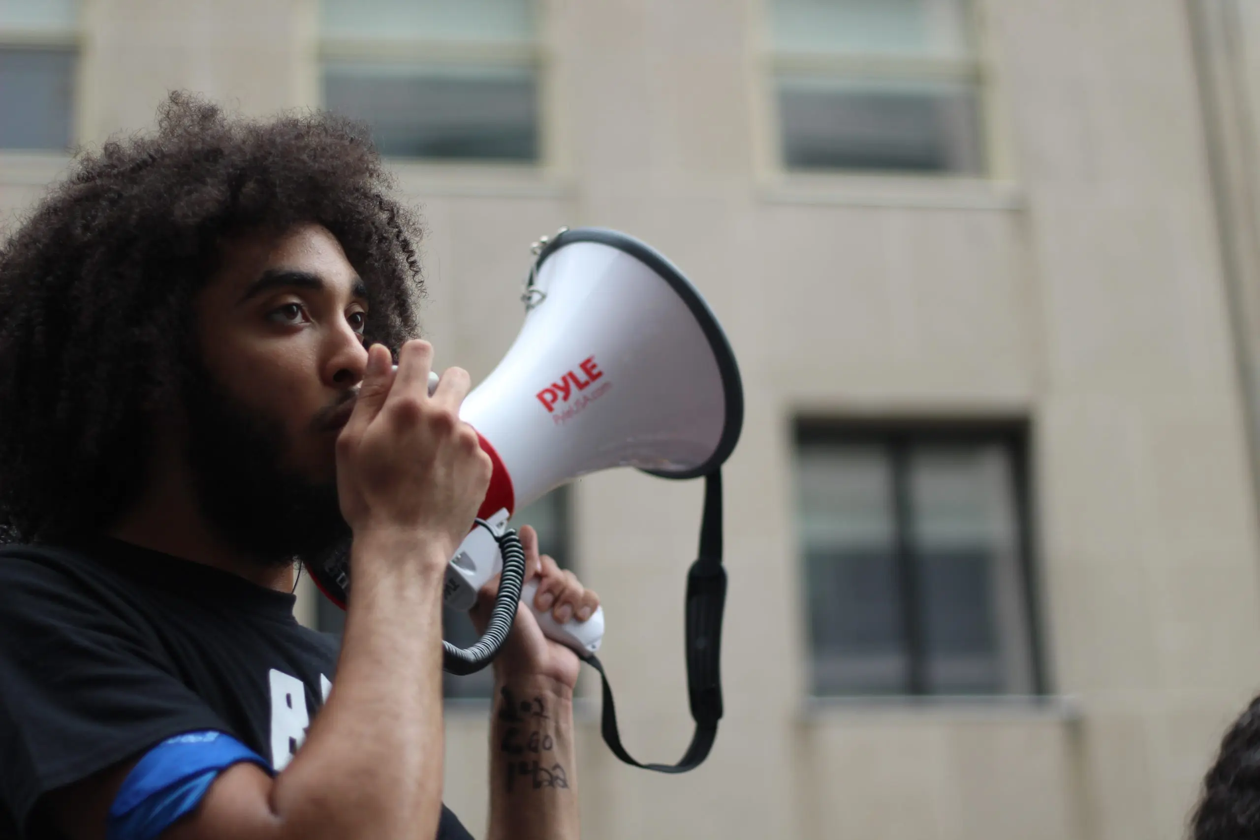 man speaking into megaphone
