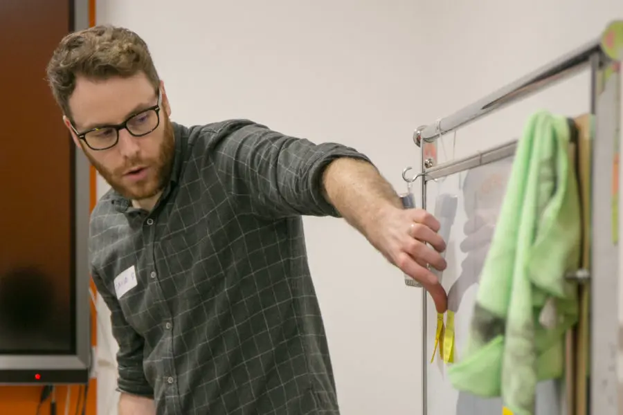 david in a design sprint pointing to a whiteboard