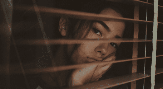 woman looking bored staring out of window