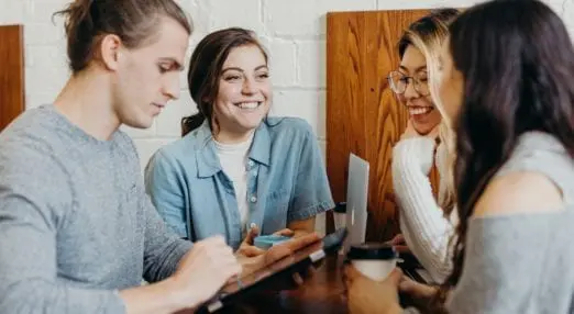 four young people sat around a table