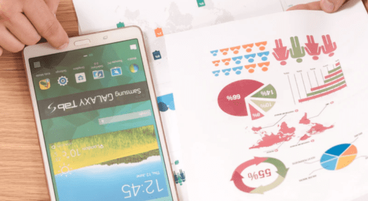 graphs on a piece of paper next to a smartphone