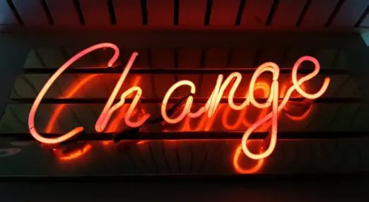 neon sign saying 'change'