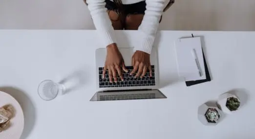 hands typing on a laptop