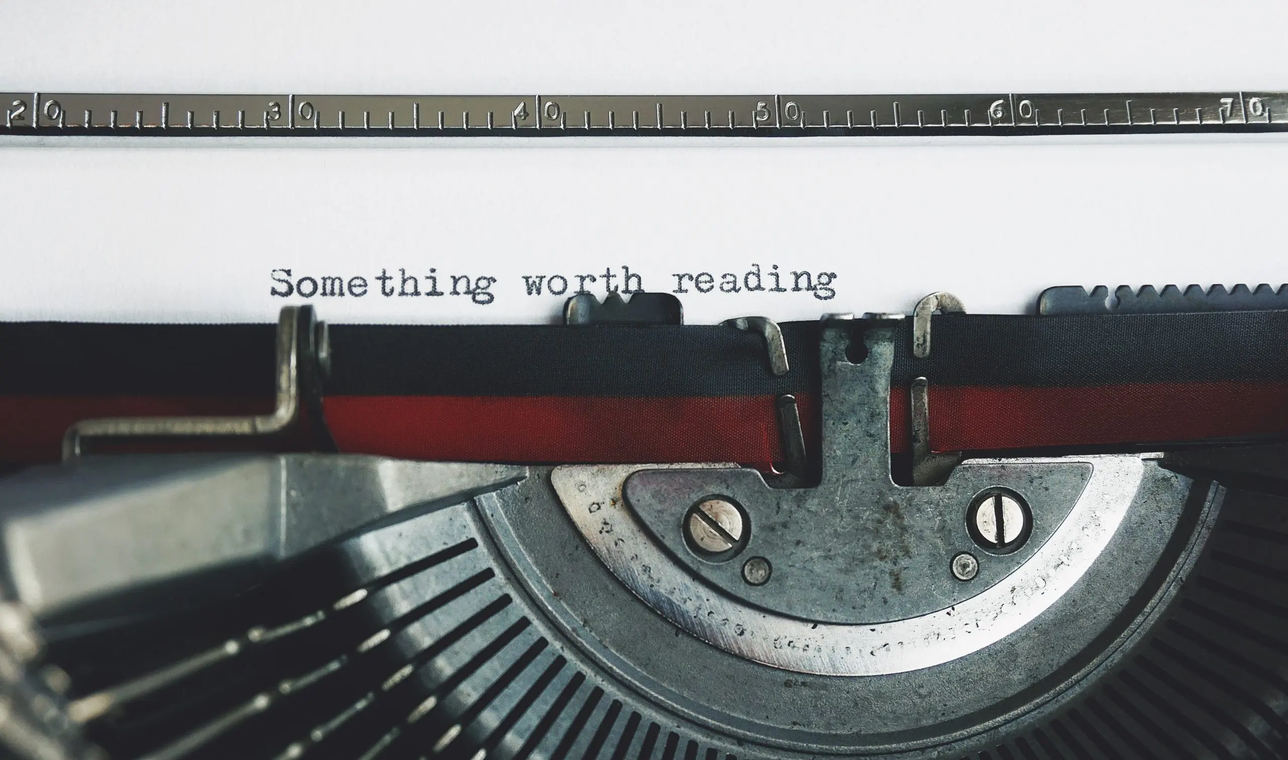 typewriter writing the words 'something worth reading'