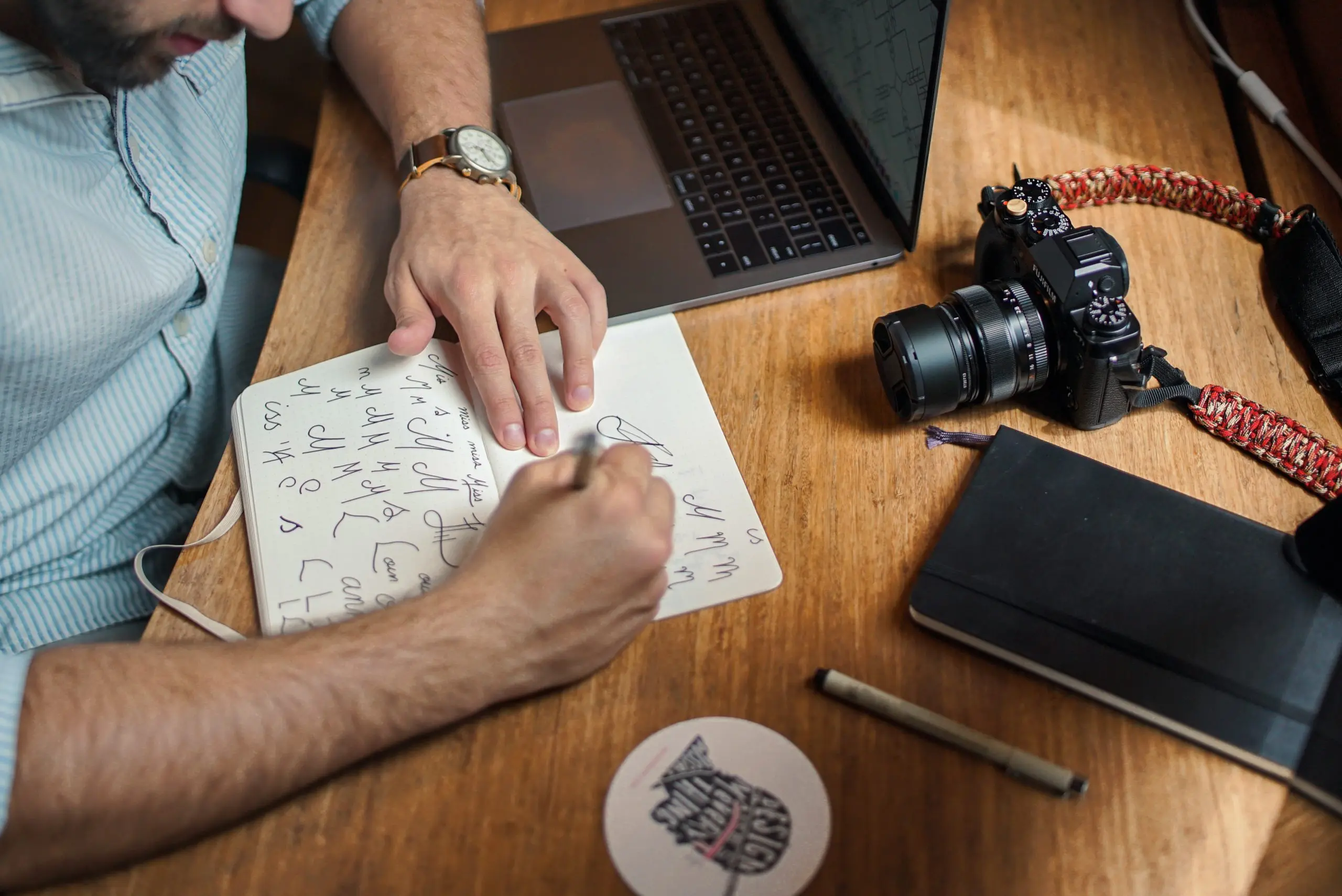 man designing typeface in a notebook