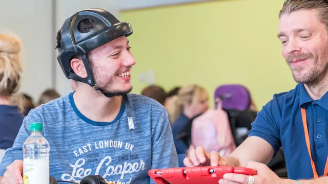 a boy and a teacher laughing together
