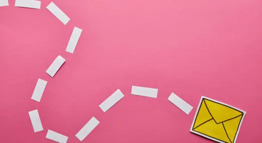 pink background. a paper-made email icon travels across the background