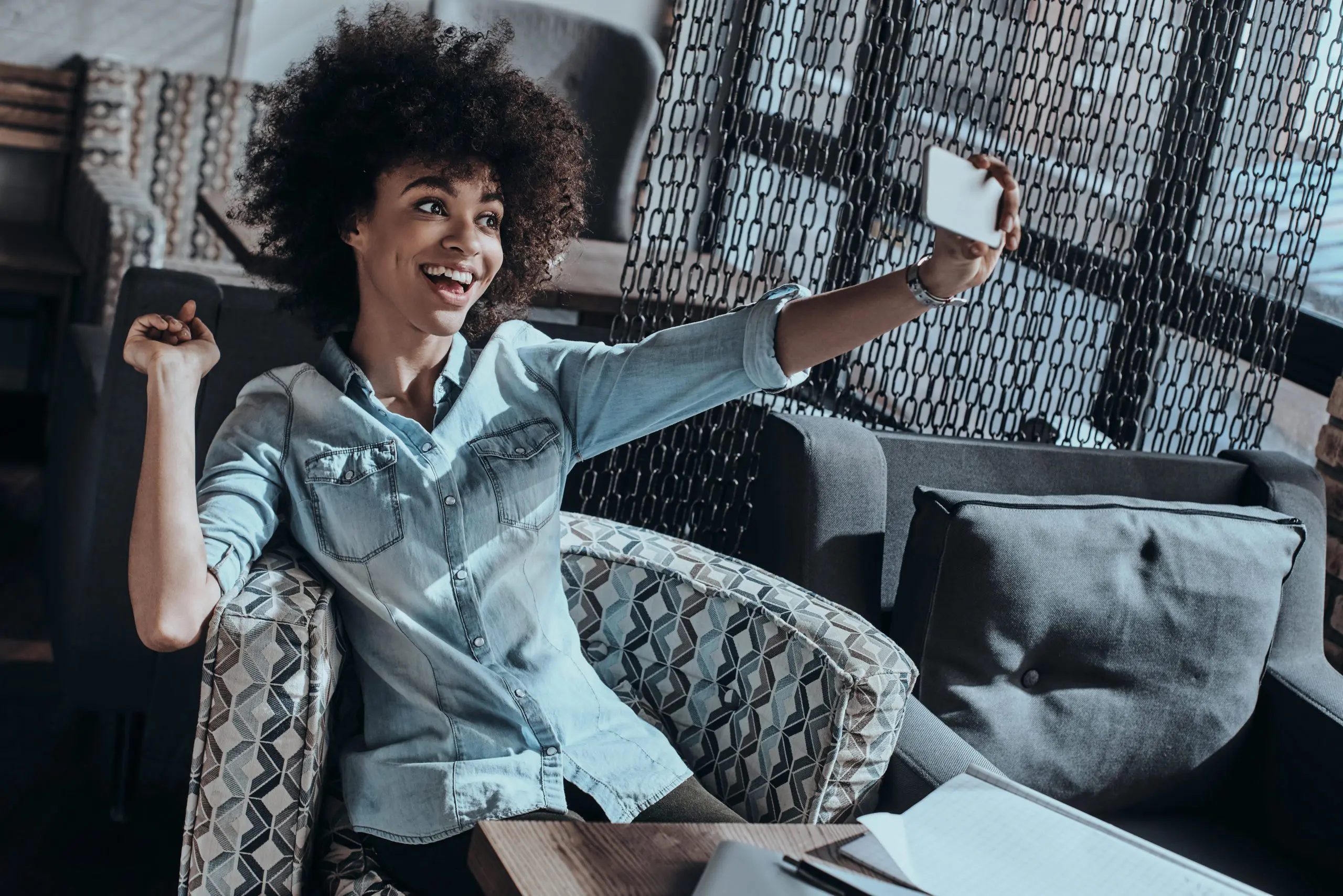 woman taking photo of herself on a couch