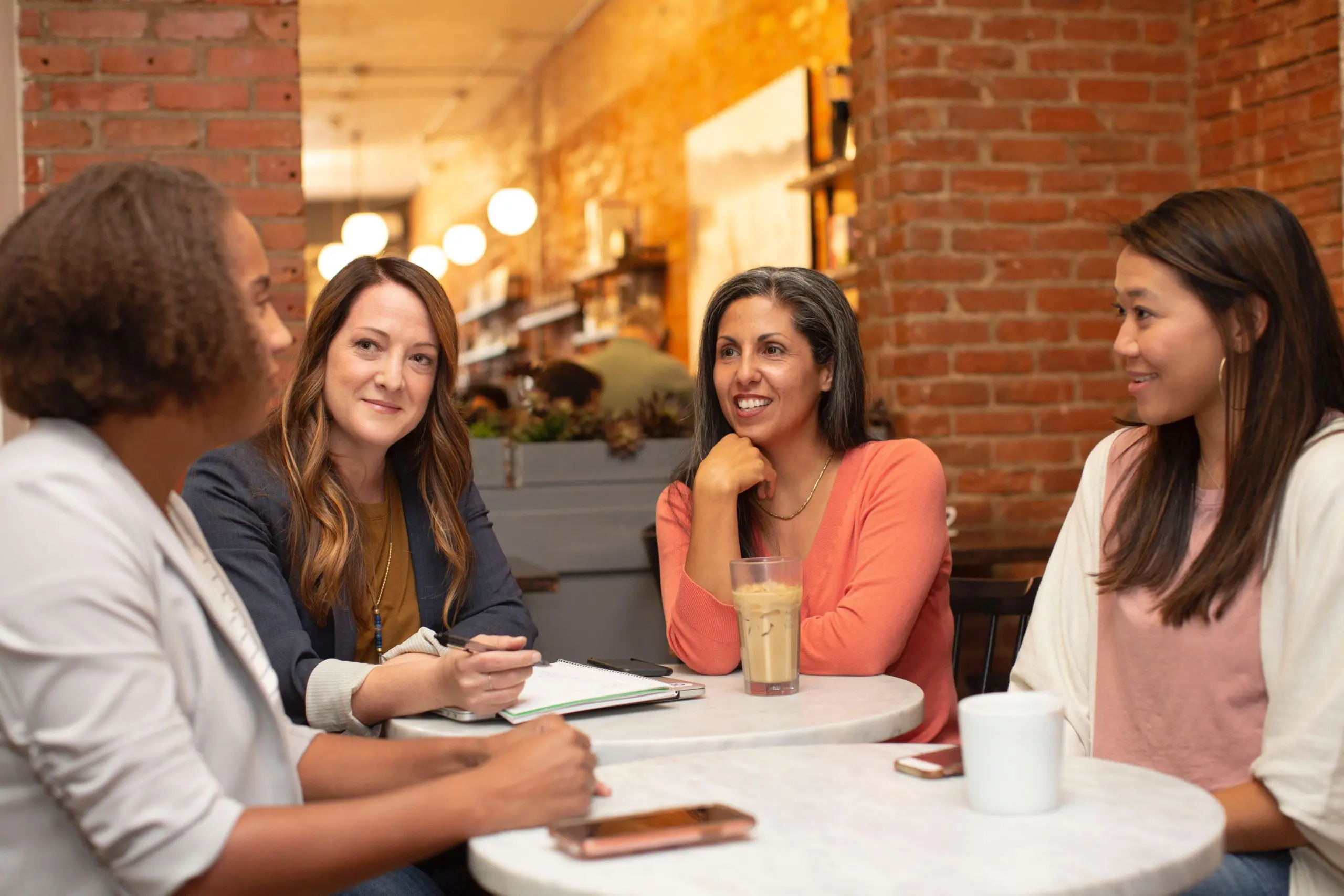 a group of four people in discussion around a table
