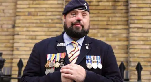 a portrait of simon, a member of blind veterans uk