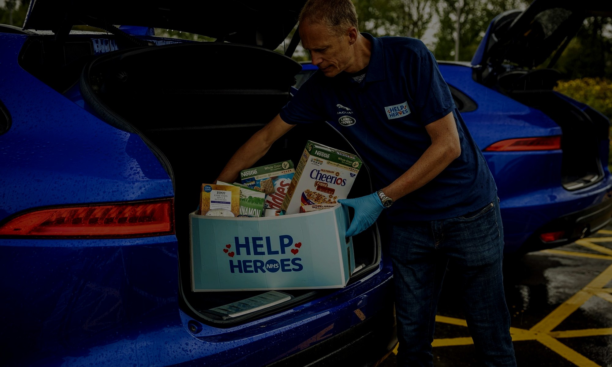 Help for heroes staff carrying food box