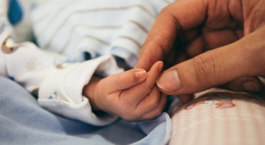 close up of holding baby's hand