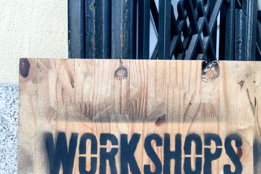 a piece of wood with the word workshops sprayed onto it