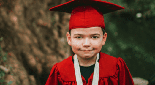 child wearing a cap and gown