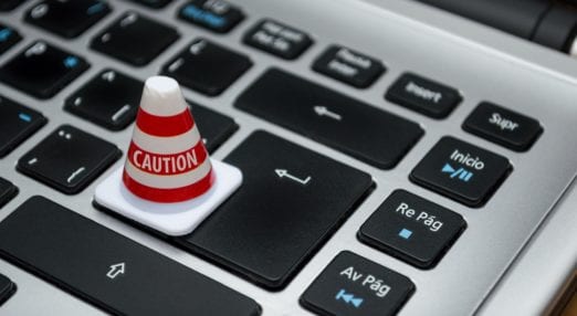 laptop keyboard with a mini caution cone over the enter button