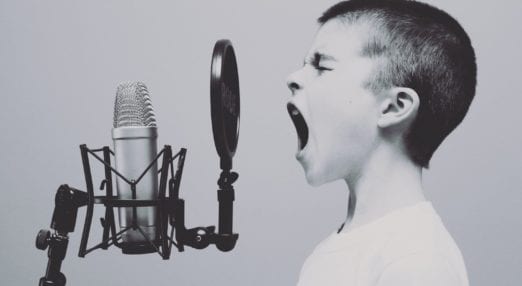 child singing into a microphone