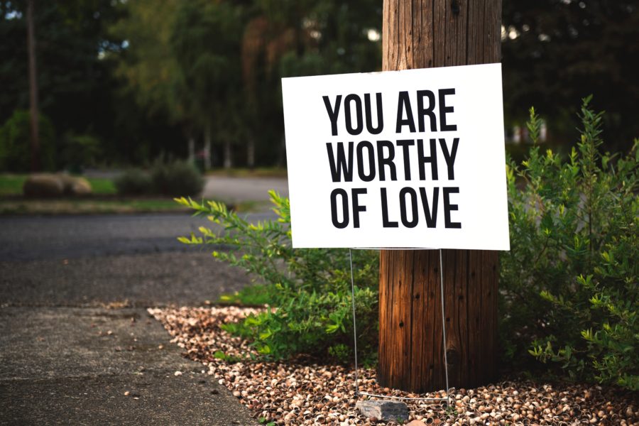sign saying 'you are worthy of love'