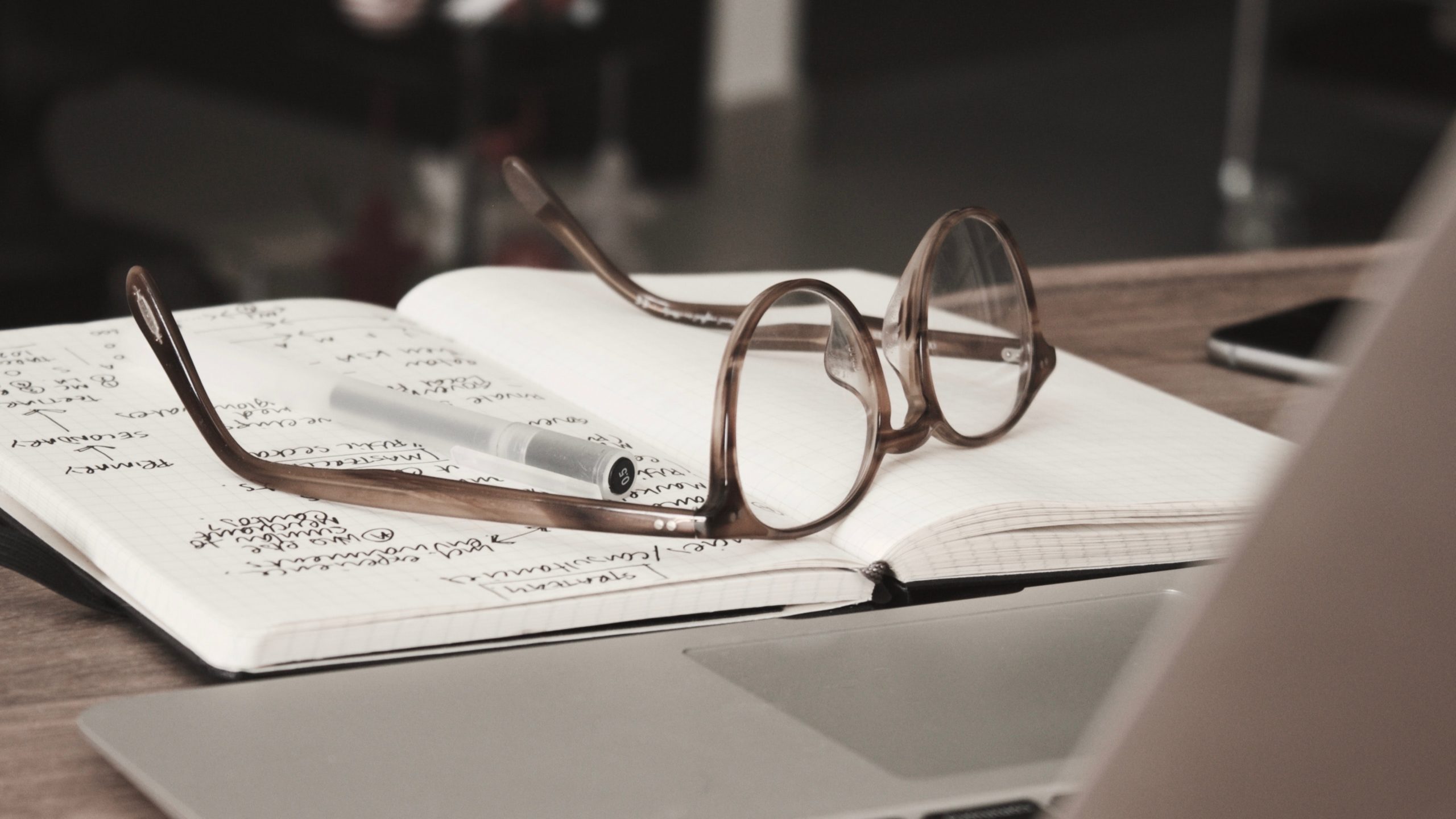 a pair of glasses on a notebook