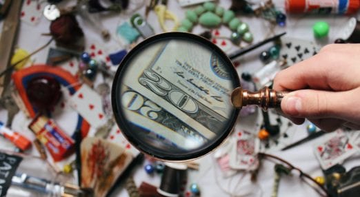 magnifying glass focusing on bank notes