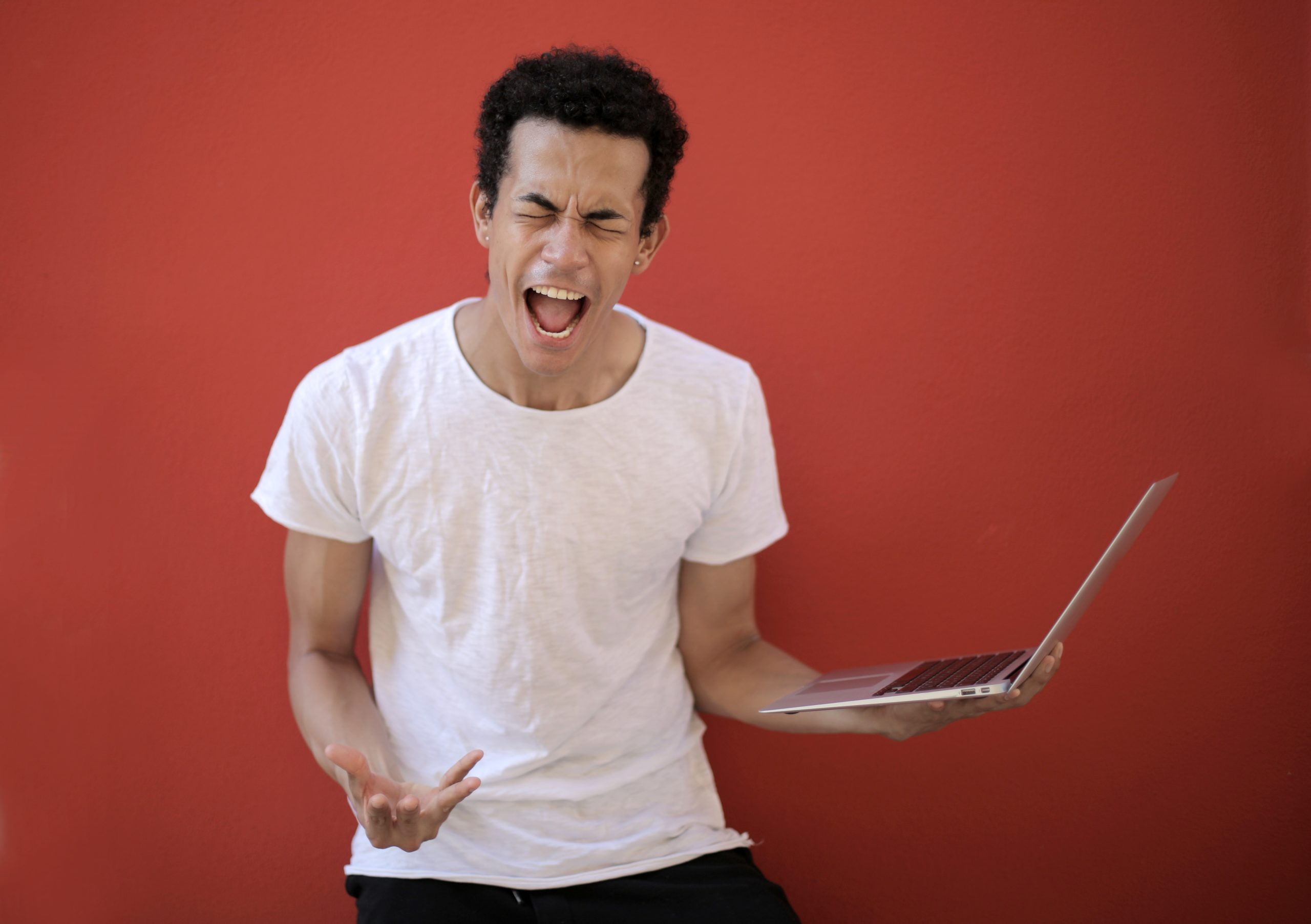 man angry at a laptop