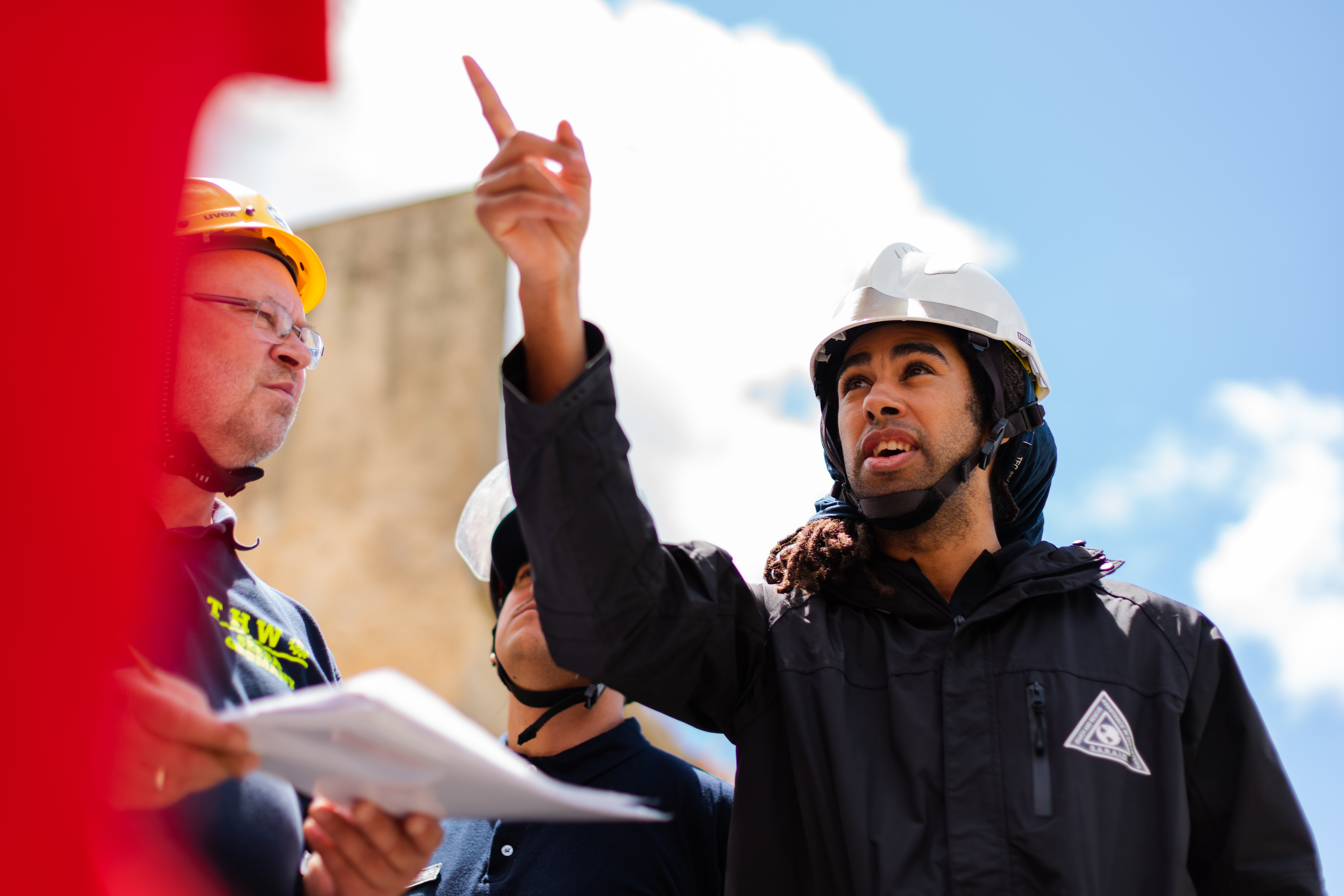 engineer wearing a helmet and pointing
