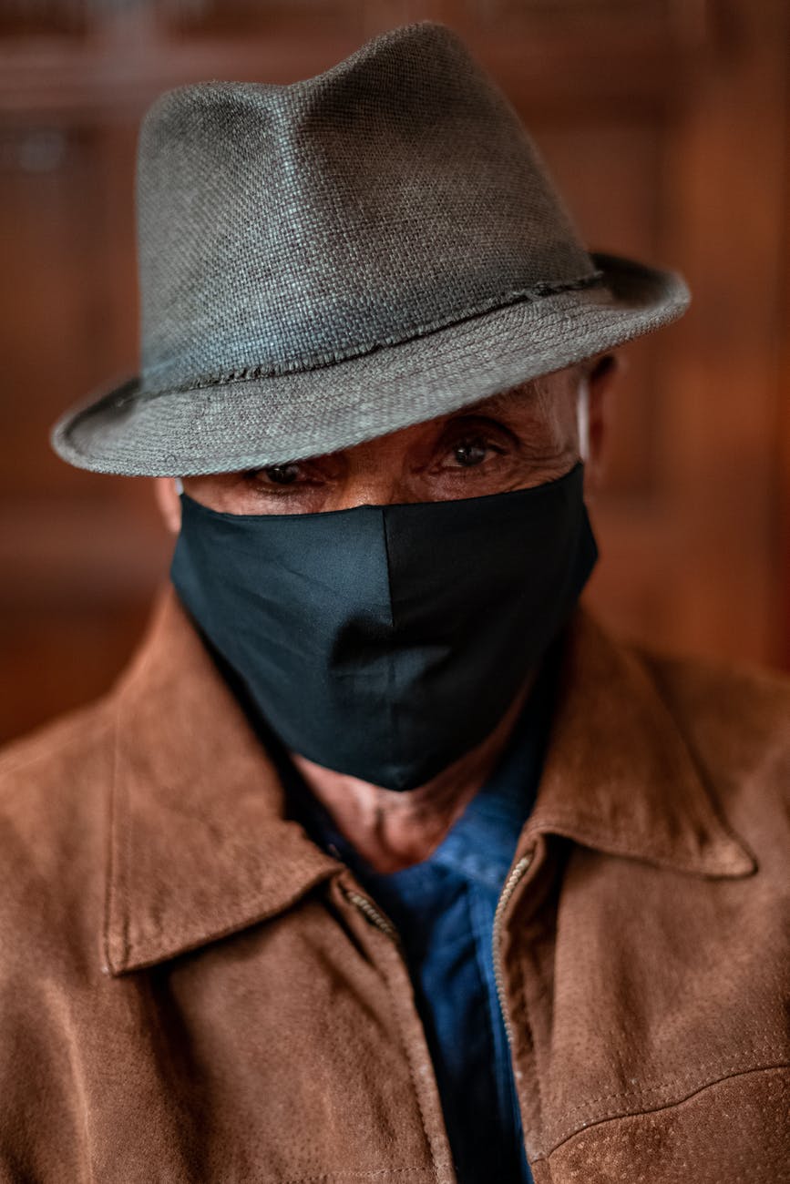 older man wearing facemask and hat