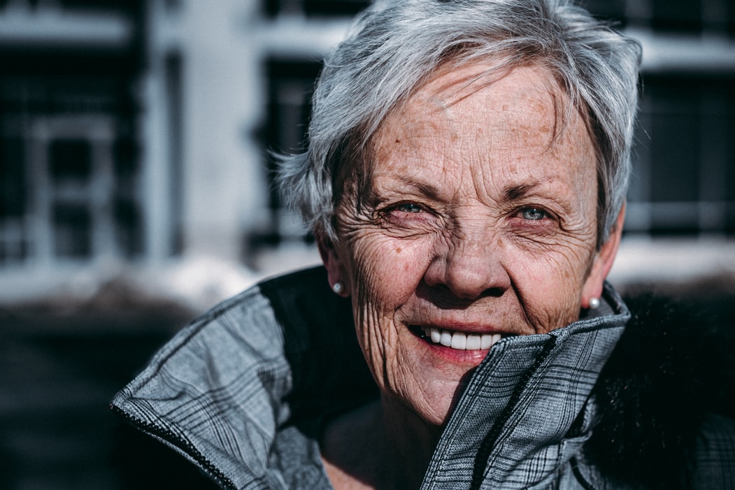 older woman close up smiling at camera
