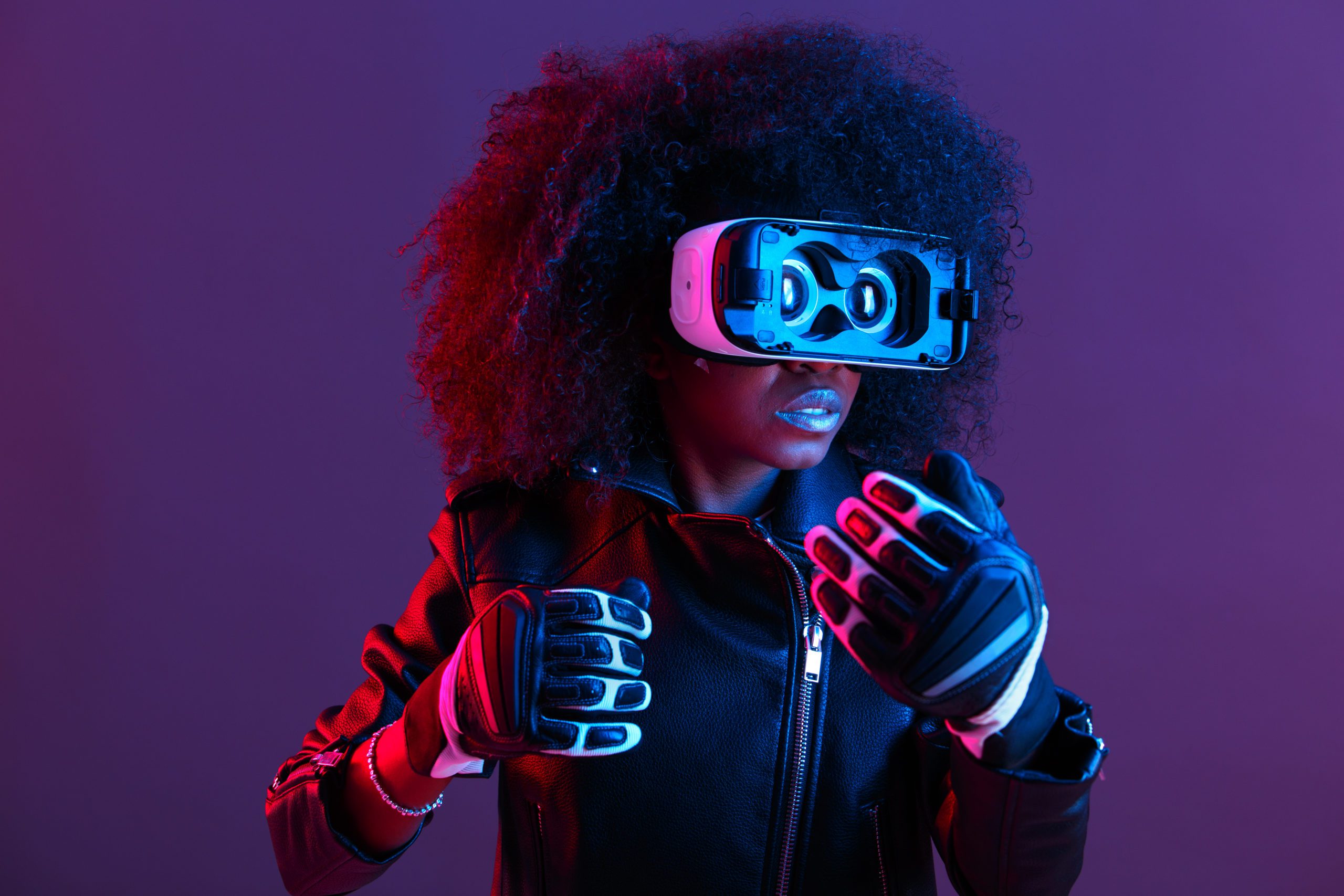 woman wearing VR goggles and gloves