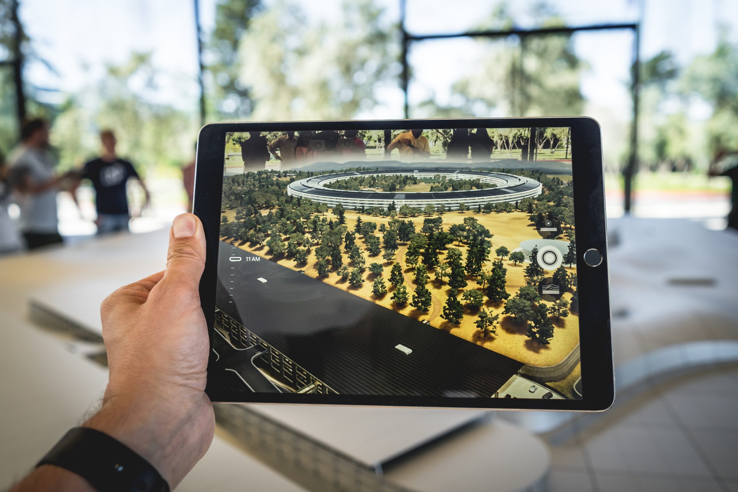 a tablet showing a virtual render of a world