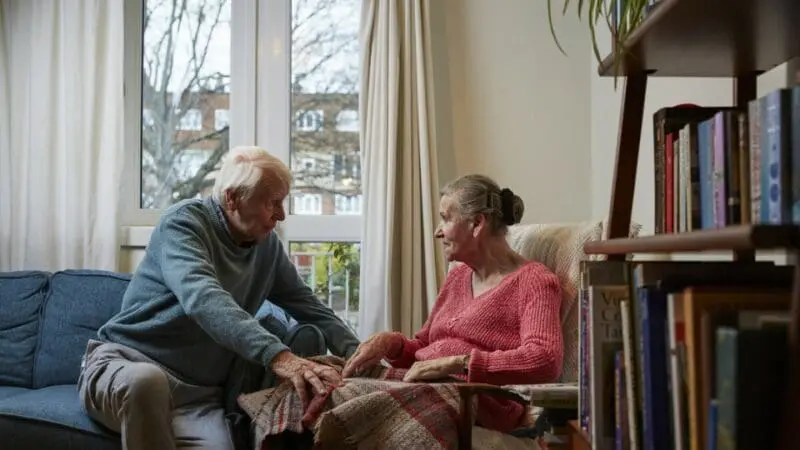 An elderly couple in their home